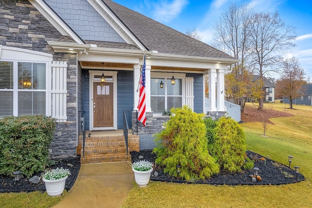 view of exterior entry featuring a yard