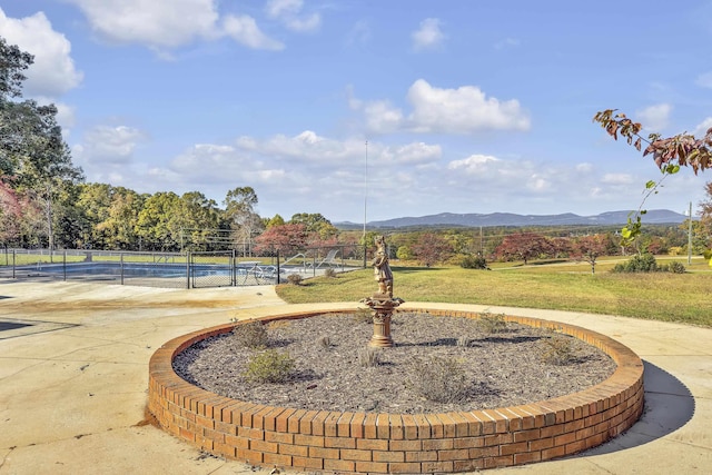 view of property's community with a pool and a mountain view