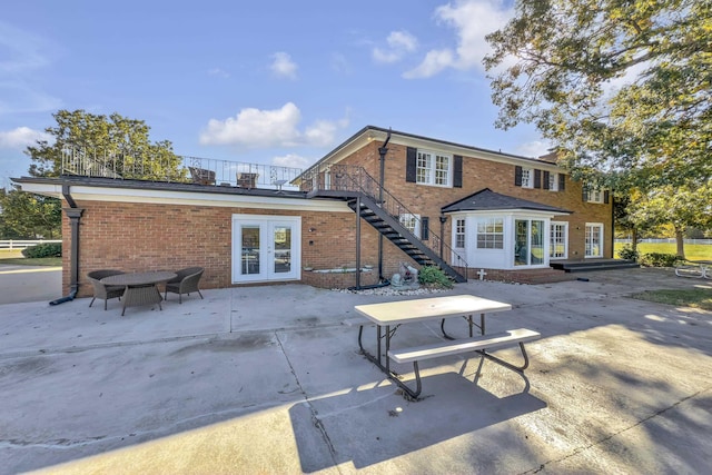 rear view of property featuring a patio and french doors