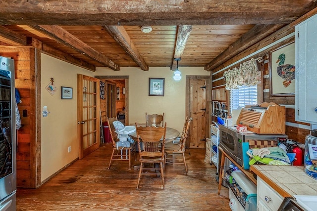 dining room with wood ceiling, beamed ceiling, and hardwood / wood-style flooring