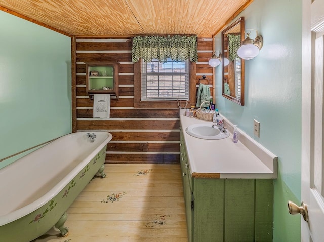 bathroom with vanity, wood-type flooring, a tub to relax in, wooden ceiling, and wood walls