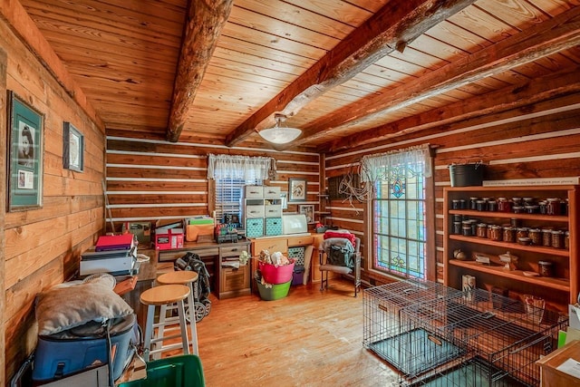 interior space with wood ceiling, wood walls, light hardwood / wood-style flooring, and beamed ceiling