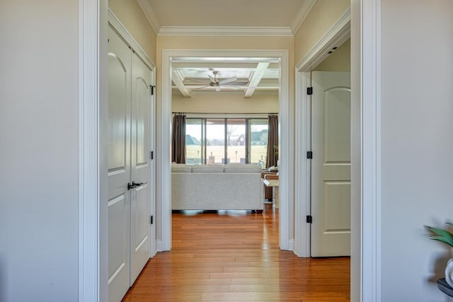 hallway featuring beam ceiling, crown molding, coffered ceiling, and light wood-type flooring