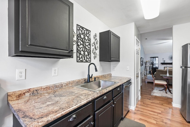 kitchen featuring stainless steel appliances, light hardwood / wood-style floors, and sink