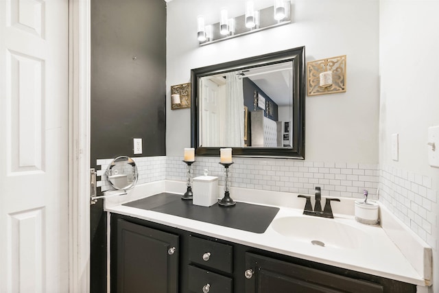 bathroom with vanity and decorative backsplash