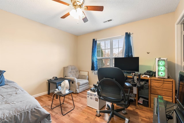 office area featuring hardwood / wood-style flooring, ceiling fan, and a textured ceiling