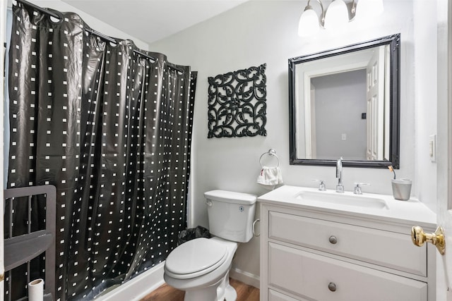 bathroom with hardwood / wood-style flooring, vanity, curtained shower, and toilet