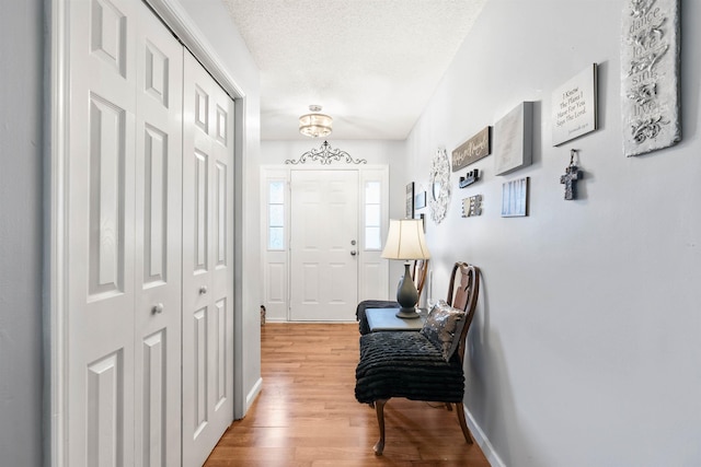 interior space featuring a textured ceiling and light wood-type flooring