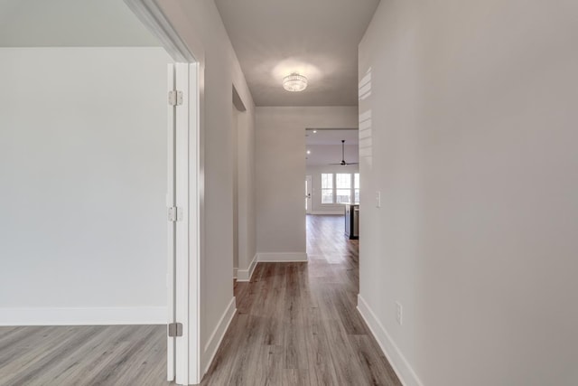 corridor with light hardwood / wood-style floors