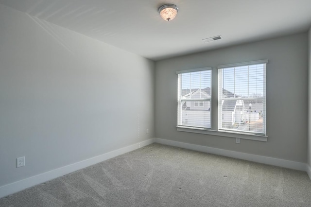 spare room with light colored carpet