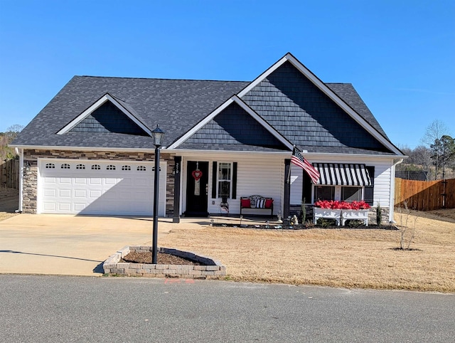 view of front of home featuring a porch and a garage