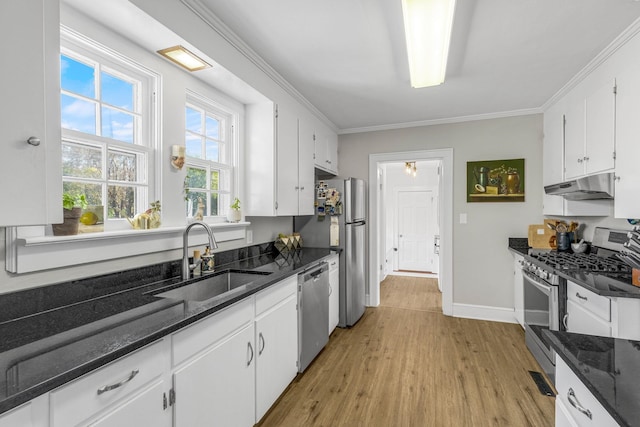 kitchen with stainless steel appliances, white cabinetry, and sink