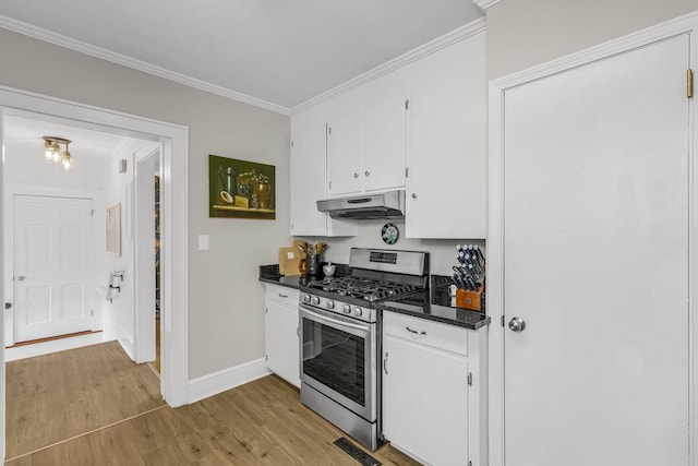 kitchen featuring ornamental molding, white cabinets, light wood-type flooring, and stainless steel gas stove