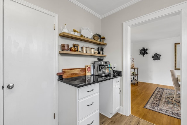 bar featuring crown molding, white cabinets, and light wood-type flooring