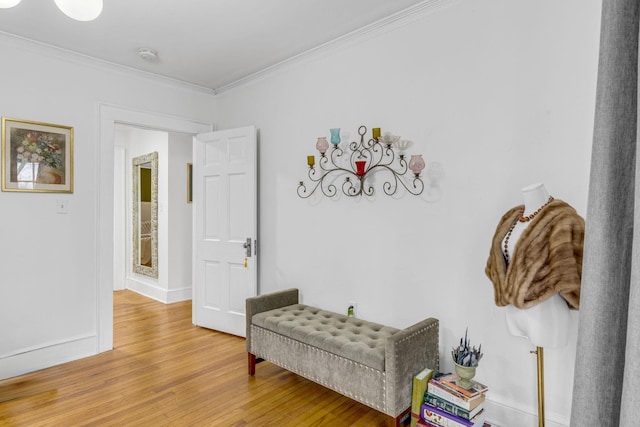 sitting room featuring hardwood / wood-style flooring and ornamental molding