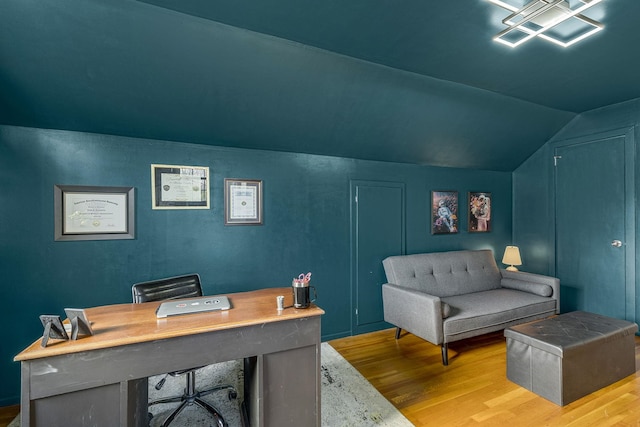 home office featuring light hardwood / wood-style flooring and vaulted ceiling