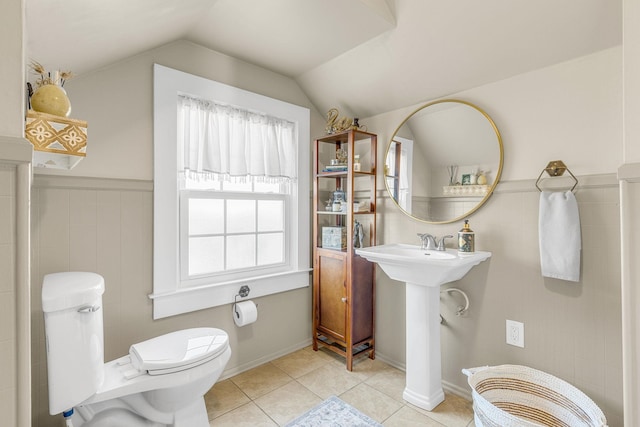 bathroom featuring lofted ceiling, tile patterned flooring, and toilet