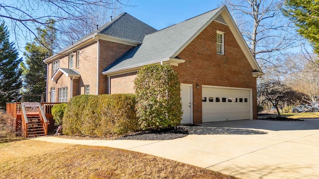 view of side of home with a wooden deck and a garage