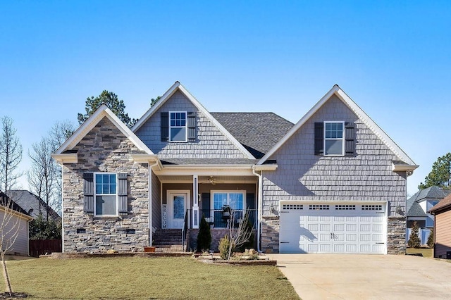 craftsman inspired home with a garage, a front lawn, and covered porch