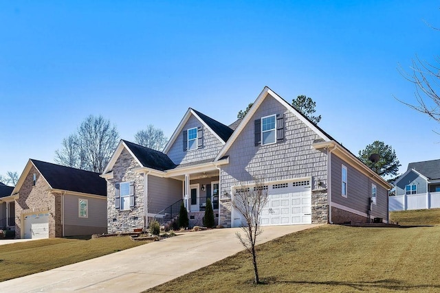 craftsman-style house with a garage, covered porch, and a front lawn