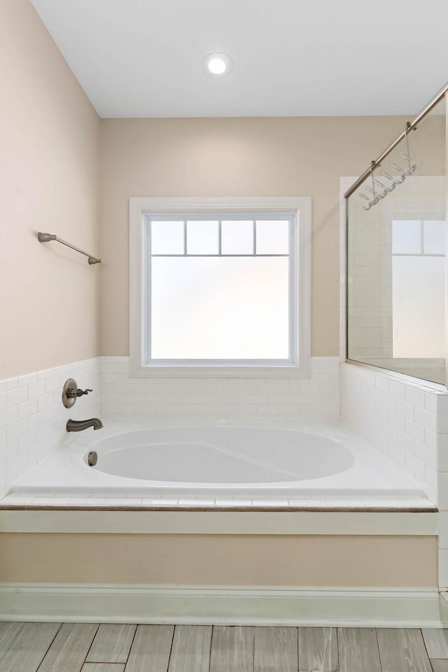 bathroom with a bath and a wealth of natural light