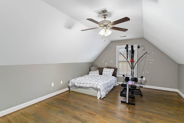 bedroom with dark wood-type flooring, ceiling fan, and vaulted ceiling