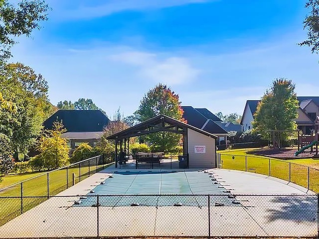 view of pool featuring a lawn and a playground