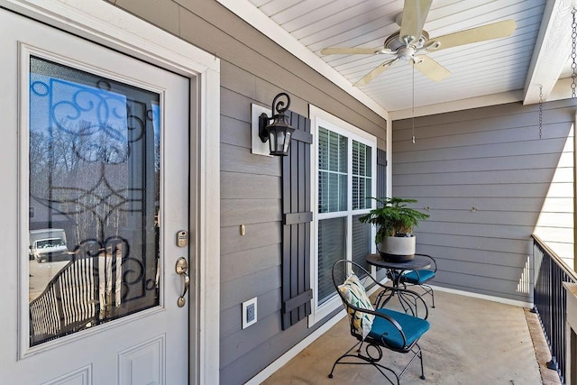 entrance to property featuring ceiling fan and covered porch