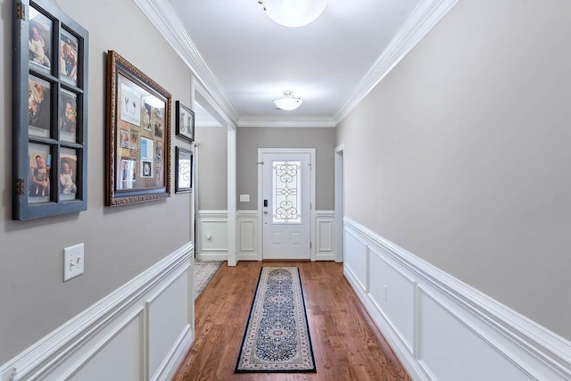 doorway featuring crown molding and hardwood / wood-style floors