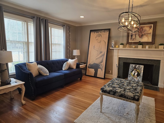 living room featuring light hardwood / wood-style flooring, ornamental molding, and a chandelier