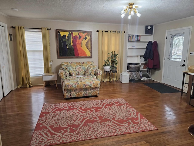 interior space with wood-type flooring, a textured ceiling, and crown molding