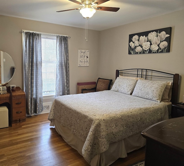 bedroom with hardwood / wood-style flooring and ceiling fan