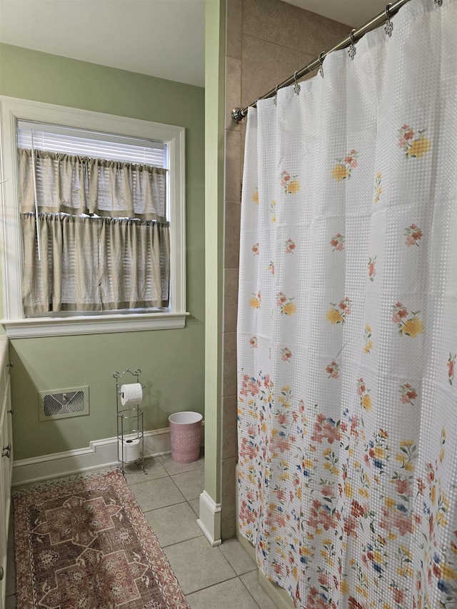 bathroom featuring tile patterned floors and walk in shower