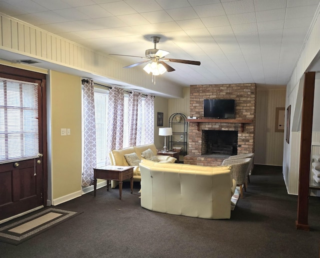 carpeted living room featuring ceiling fan and a fireplace