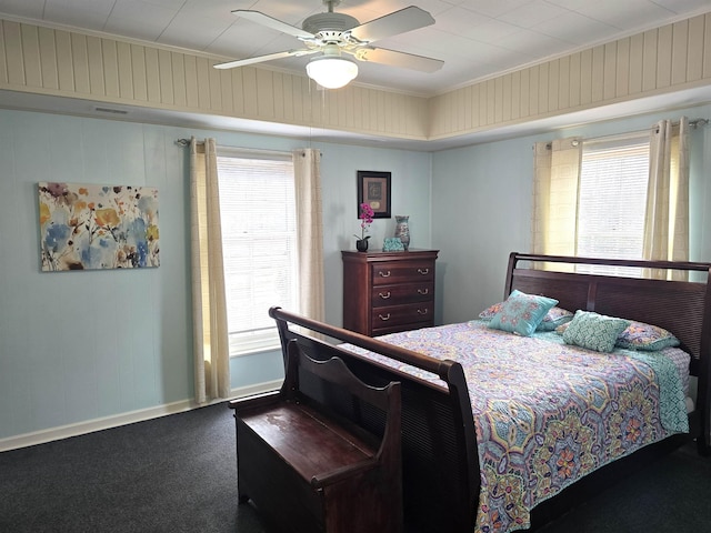 carpeted bedroom with multiple windows, ornamental molding, and ceiling fan