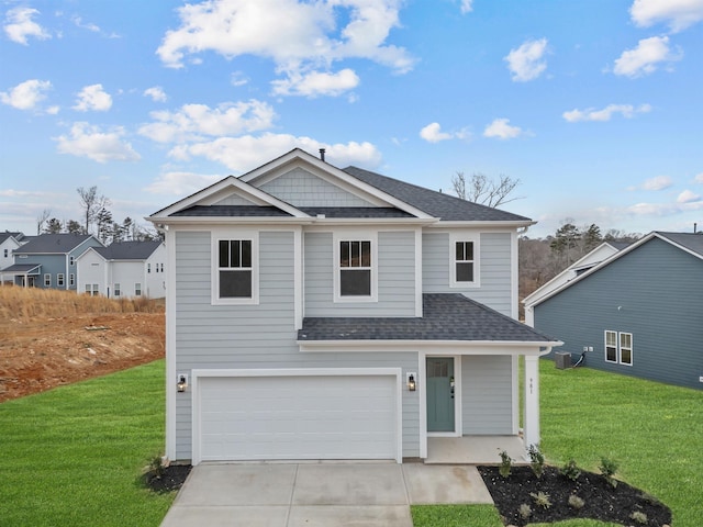 view of front of house with a garage and a front lawn