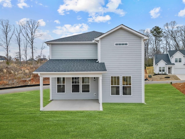 back of house featuring a patio and a lawn