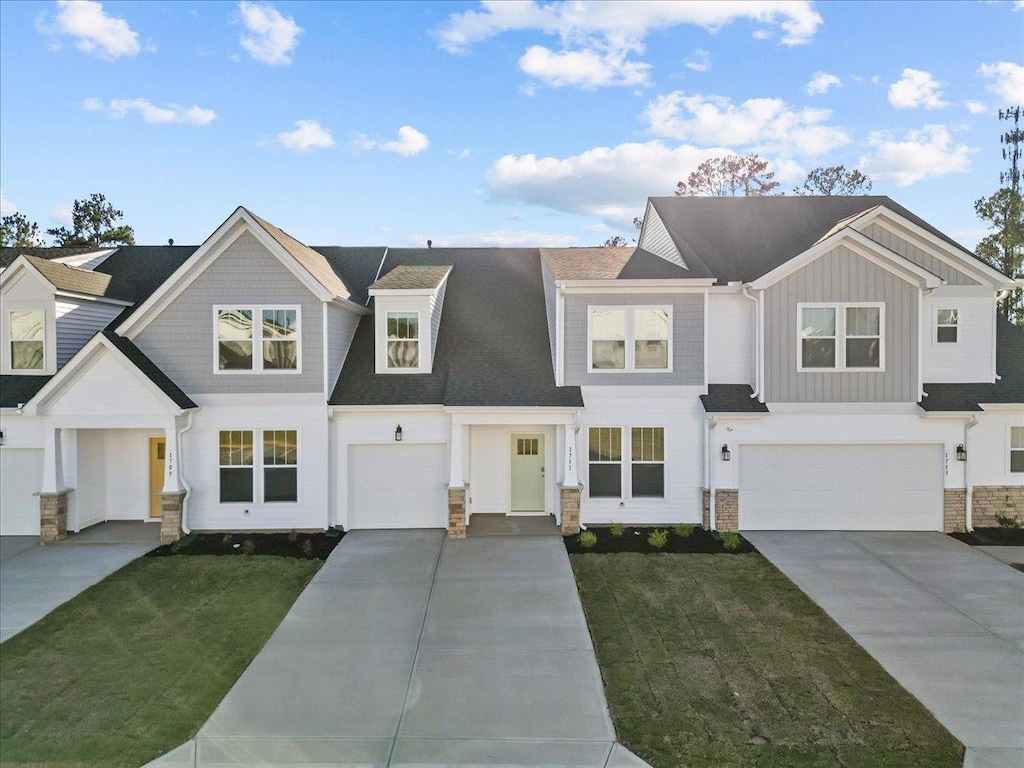 view of front of house with a garage and a front yard