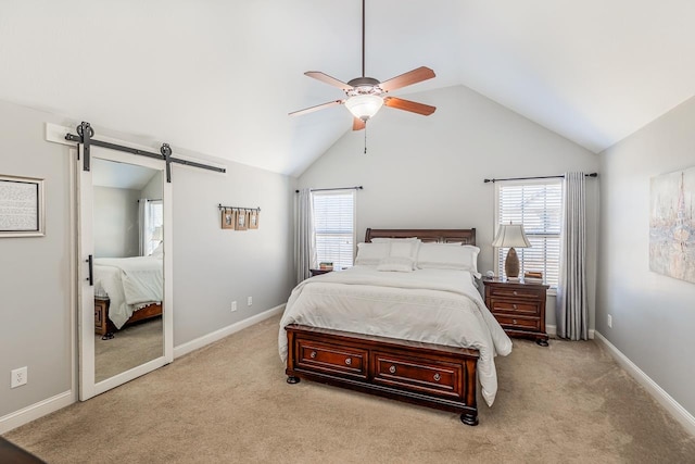 carpeted bedroom featuring vaulted ceiling, a barn door, and ceiling fan