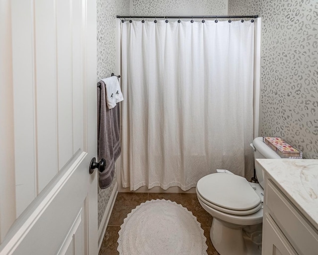 full bathroom featuring vanity, tile patterned floors, toilet, and shower / tub combo with curtain