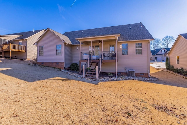 rear view of house with central AC and a porch