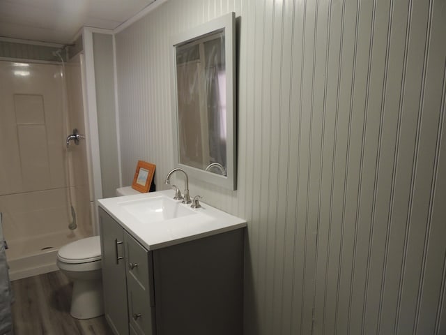 bathroom with vanity, hardwood / wood-style flooring, toilet, and a shower