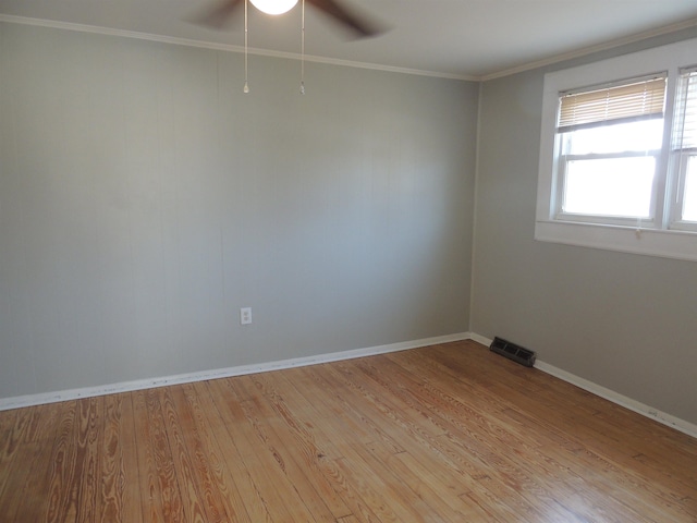 empty room featuring crown molding, light hardwood / wood-style flooring, and ceiling fan