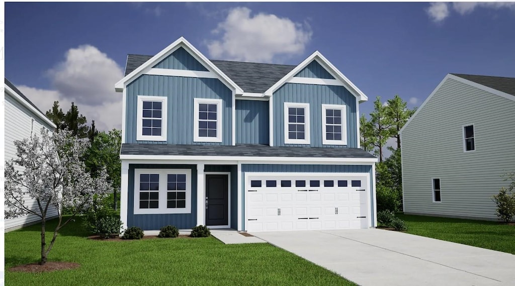 view of front of home with a garage and a front yard