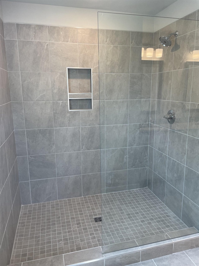 bathroom with tiled shower