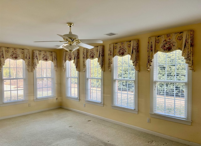 unfurnished dining area with ceiling fan and carpet flooring