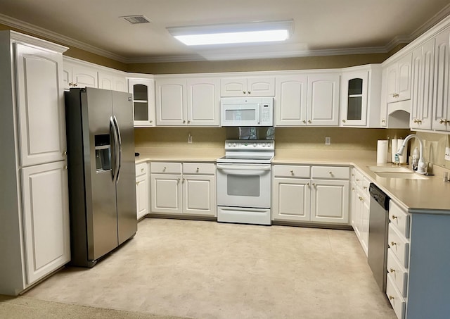 kitchen with ornamental molding, appliances with stainless steel finishes, sink, and white cabinets