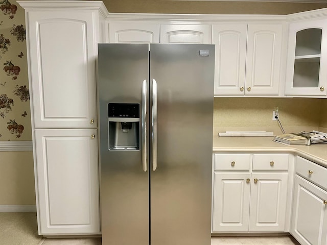 kitchen with white cabinetry and stainless steel fridge