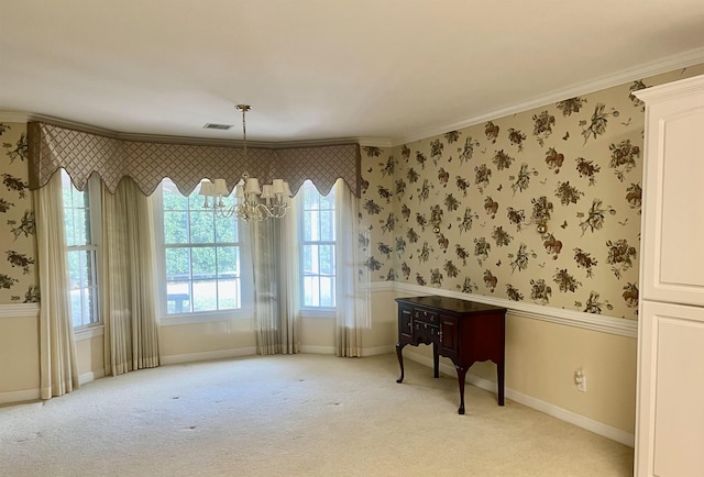 interior space with light carpet, ornamental molding, and an inviting chandelier