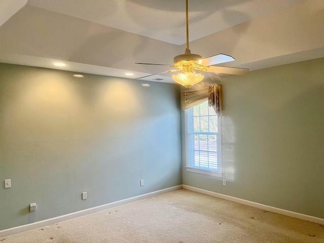 carpeted spare room with ceiling fan